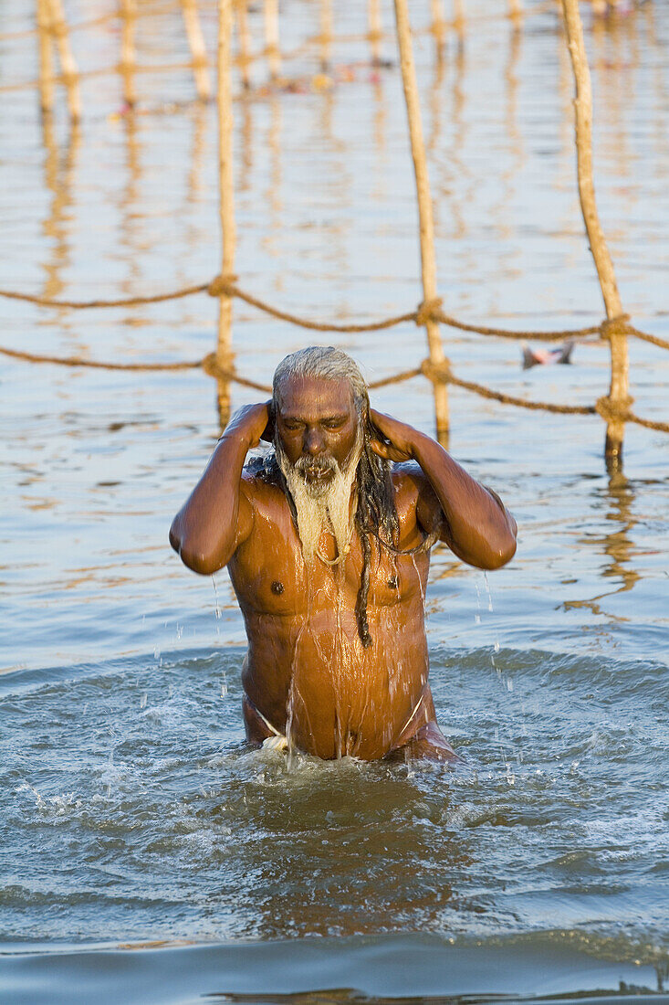 Sadhu bathing in the Ganges at Kumba Mela festival, Allahabad, Uttar Pradesh, India