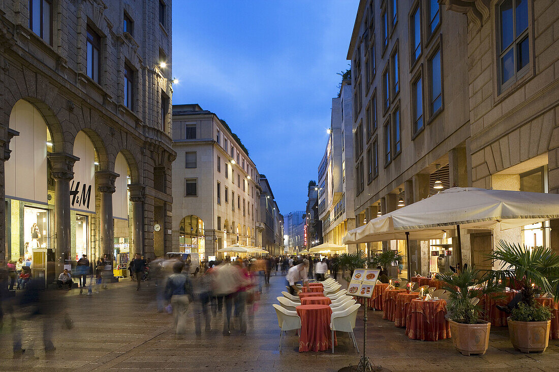 View down Corso Vittorio Emanuelle II and restaurant, Milan, Lombardy, Italy