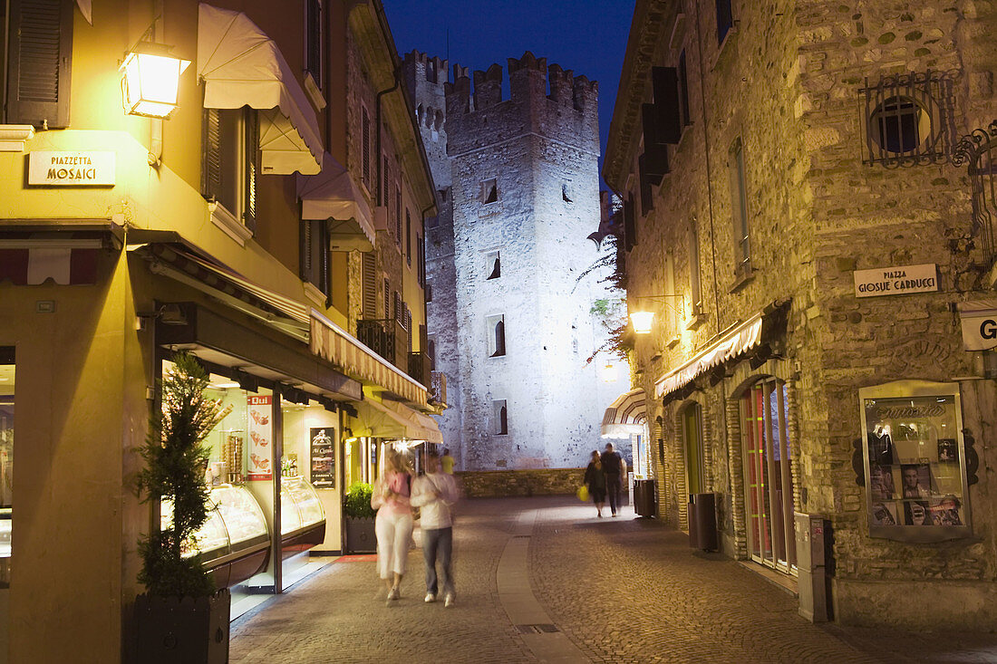 Street and castle illuminated, Sirmione, Lombardy, Italy