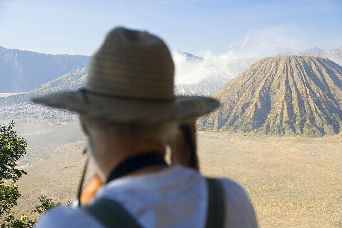 Bromo-Tengger-Semeru National Park, Gunung Bromo Volcano, Java, Indonesia . Man taking photograph of Bromo Volcano