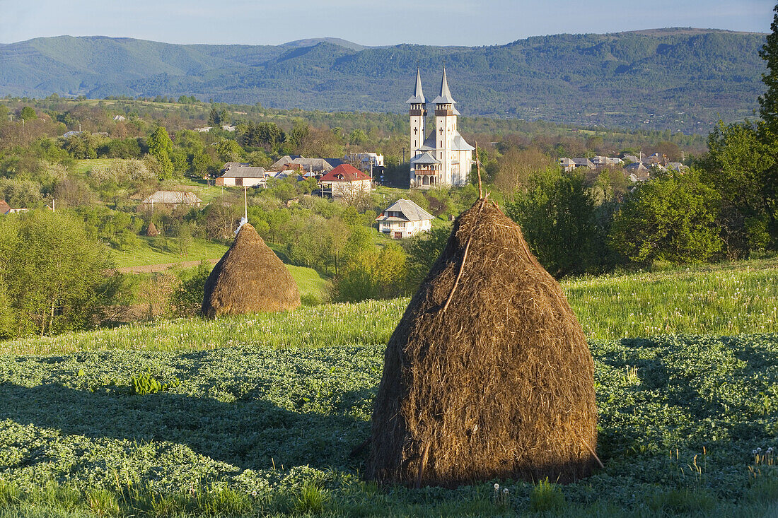 Church & hay stacks, Breb, Maramures, Romania