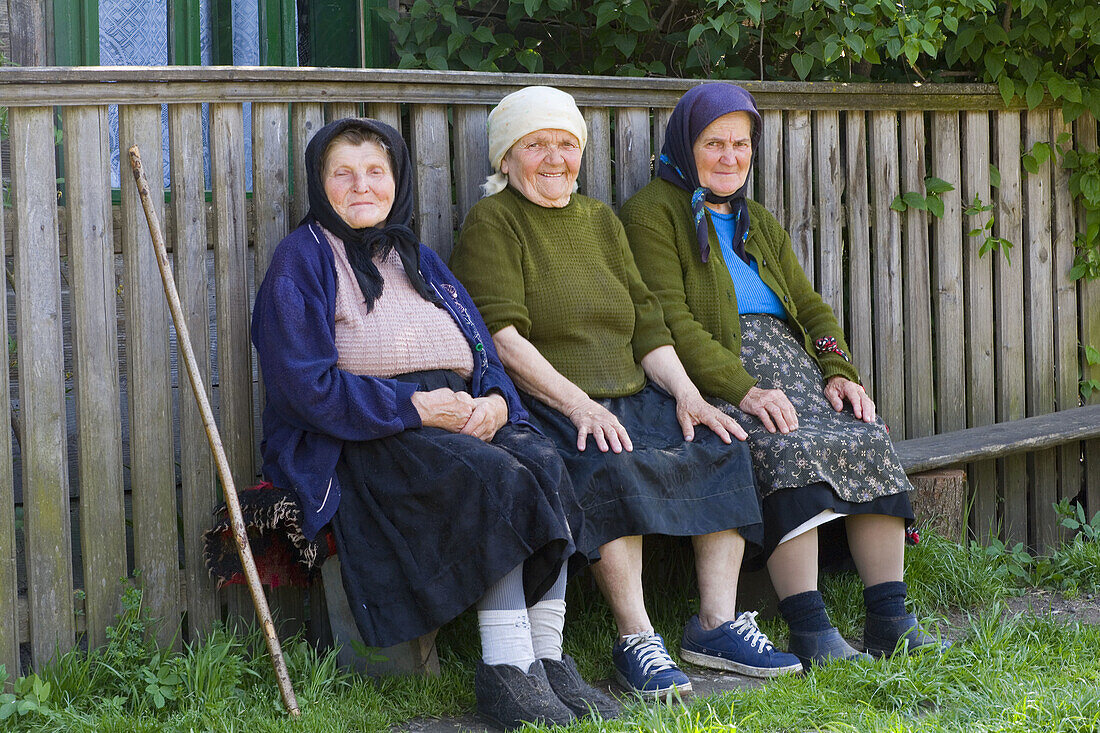 Three elderly ladies on a bench, Botiza, Maramures, Romania