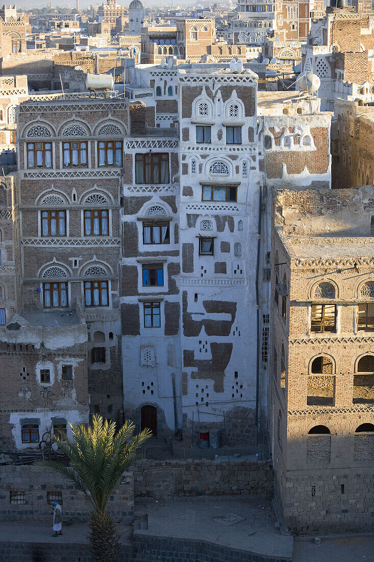 Man passing buildings, Sana, Yemen