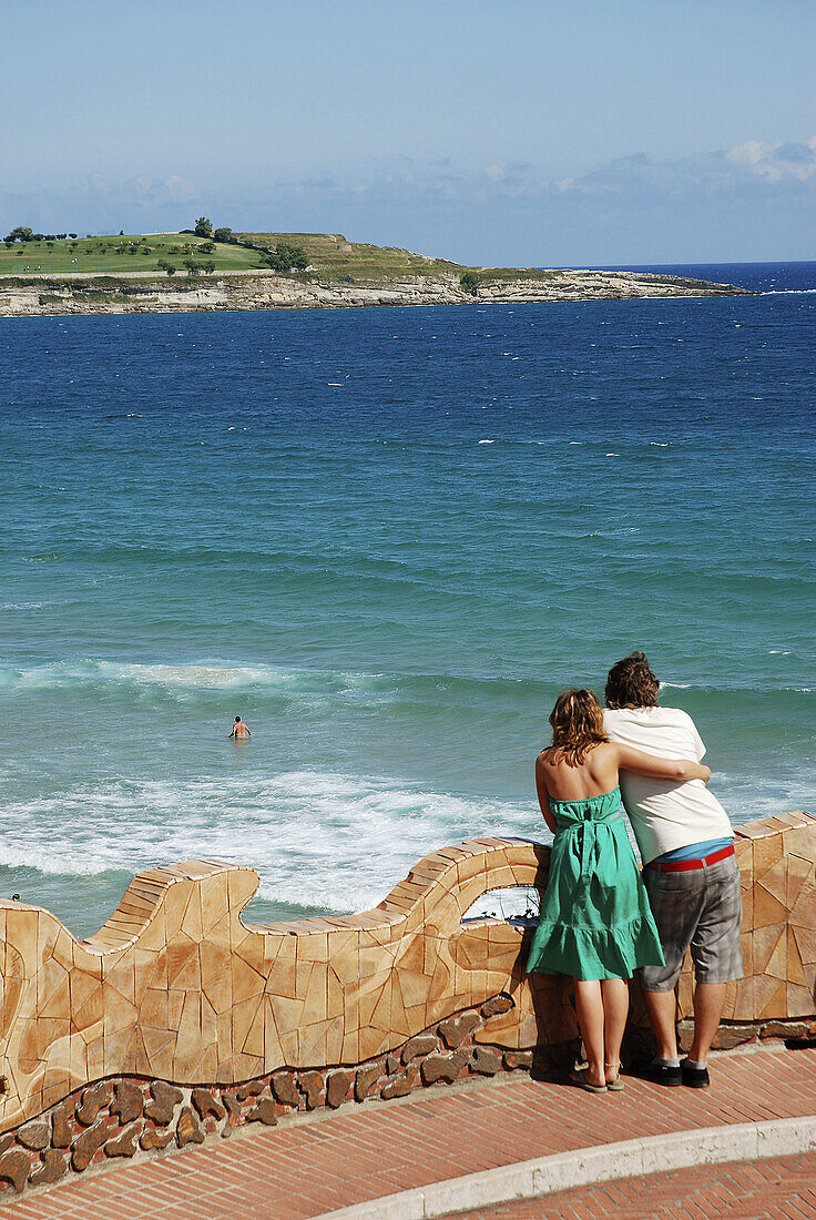 Young couple looking at the sea from a viewpoint  Piquío gardens  Santander  Cantabria province  Spain