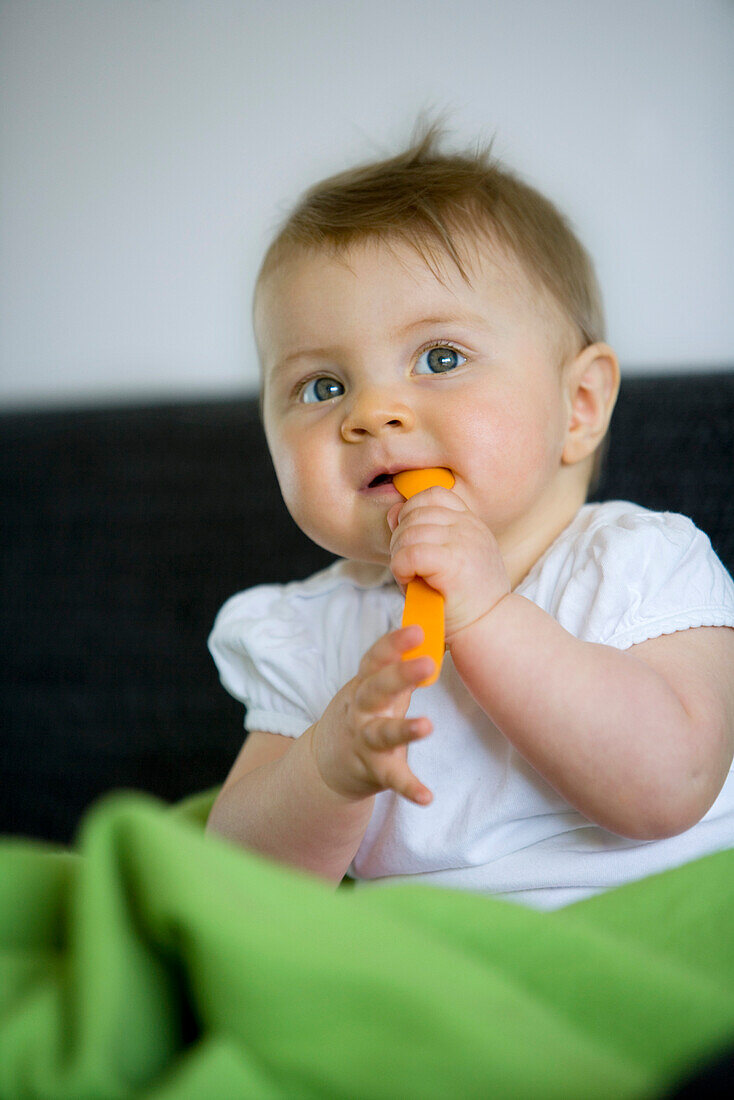 Baby girl (8 month) with a spoon, Vienna, Austria