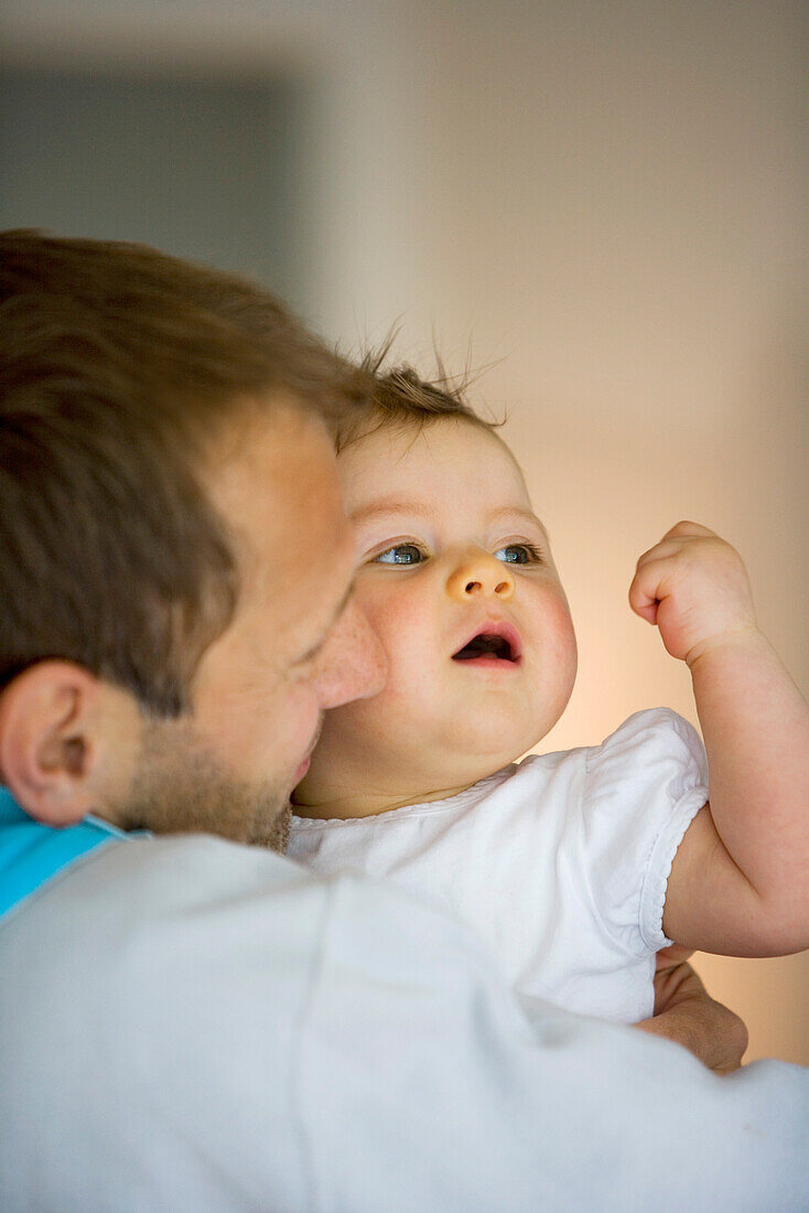 Father holding baby girl (8 month), Vienna, Austria