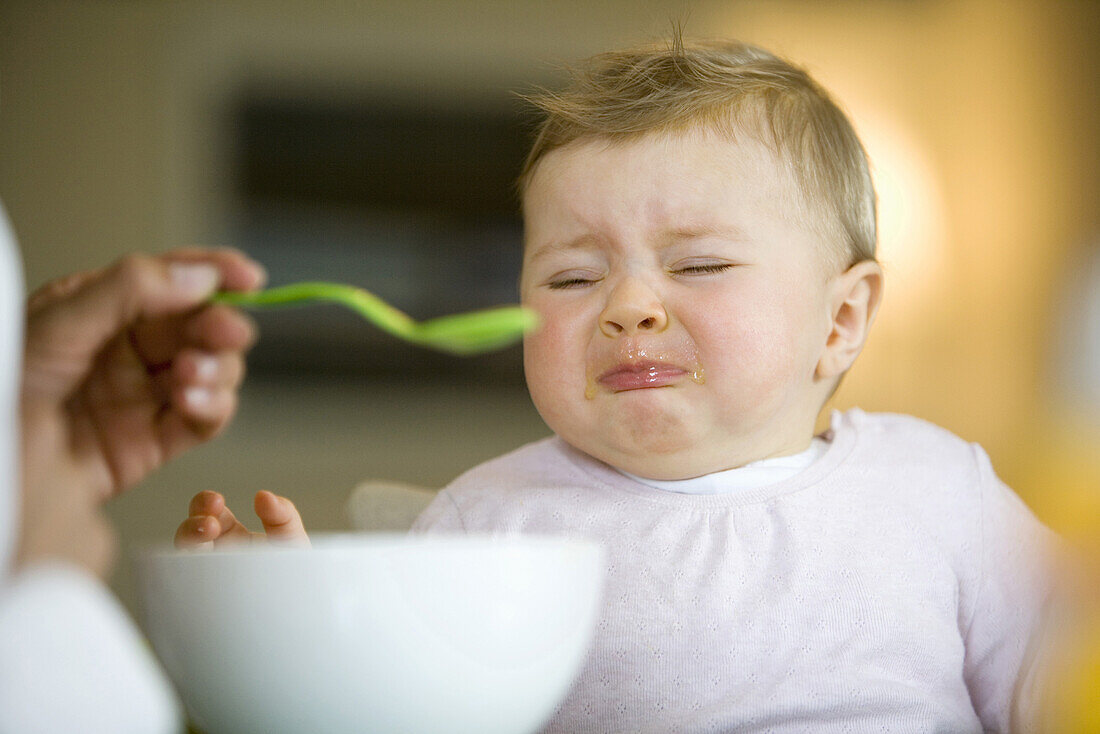 Baby girl (8 month) crying while eating, Vienna, Austria