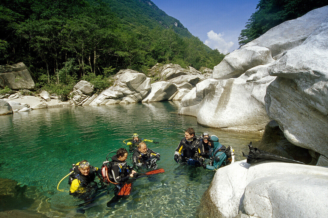 Divers in a lake at Valle Verzasca, Ticino, Switzerland, Europe