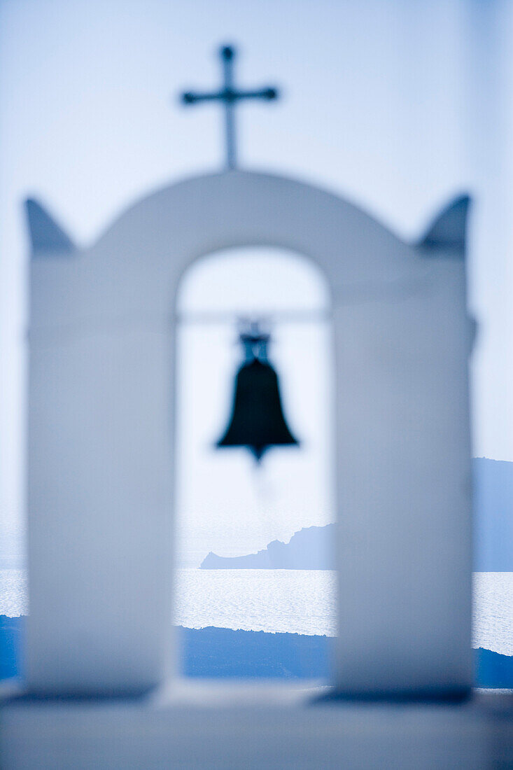 Bell tower of an orthodox church and coastline in the sunlight, Fira, Santorini, Greece, Europe