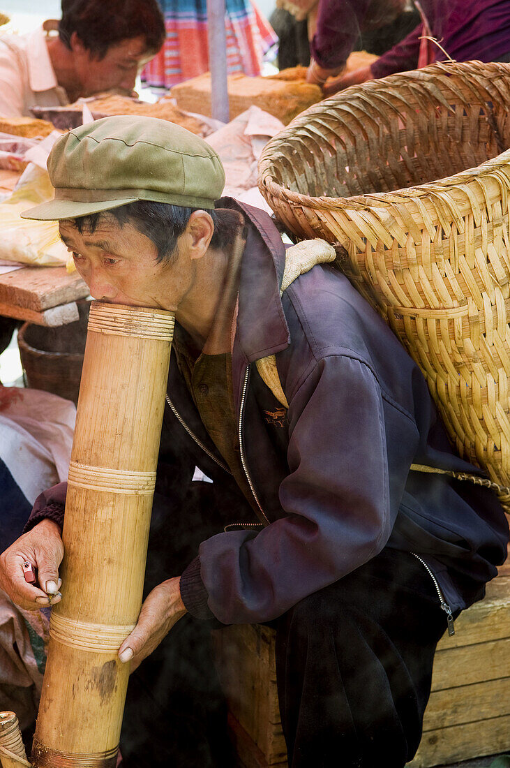 Traditional smoke via a big bamboo pipe in Yunnan province, China