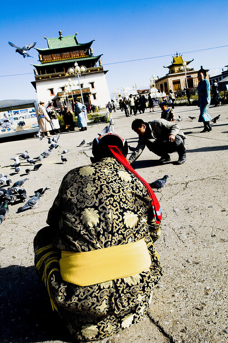 Mongolian nomads visit a famous temple in the capital city of Ulan Batarr