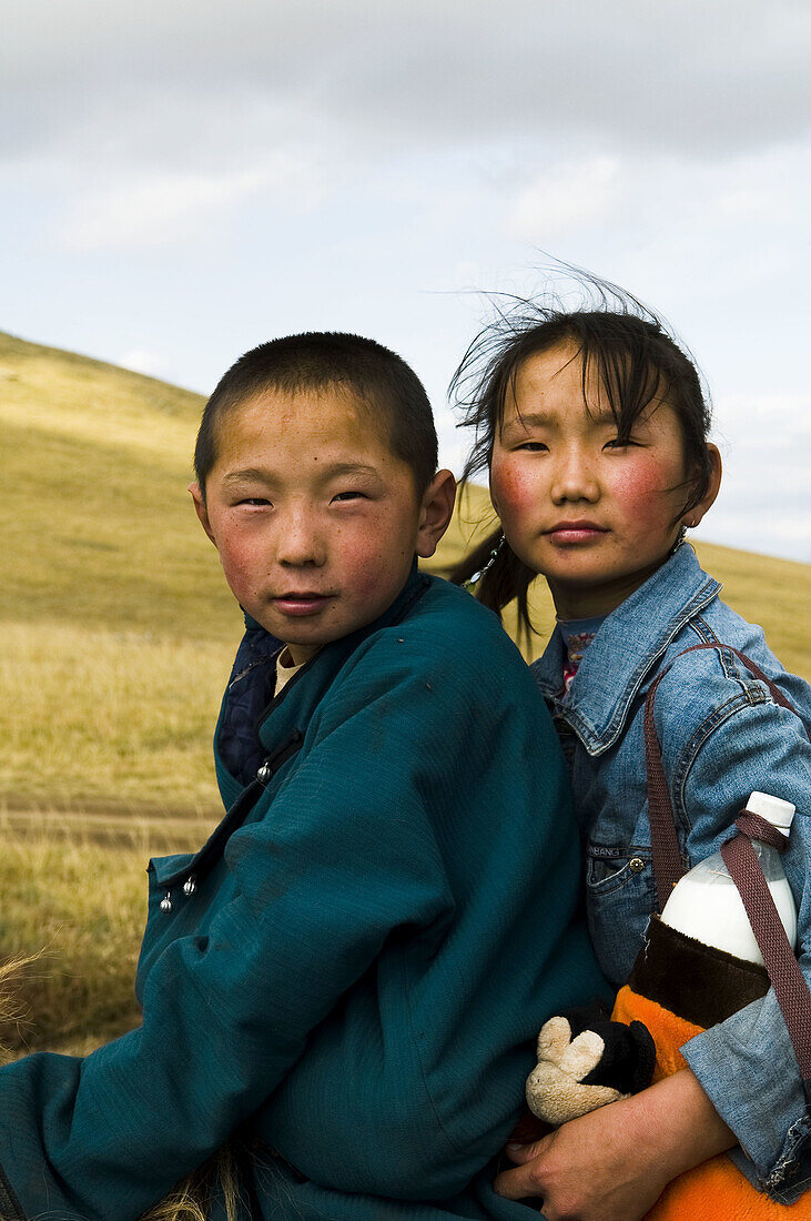 Young Mongolian nomads on their horses