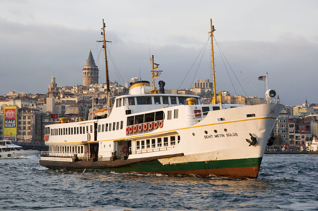 Boat crossing the Bosphorous with the Galata Tower in background Karaköy district Golden Horn Istanbul Turkey