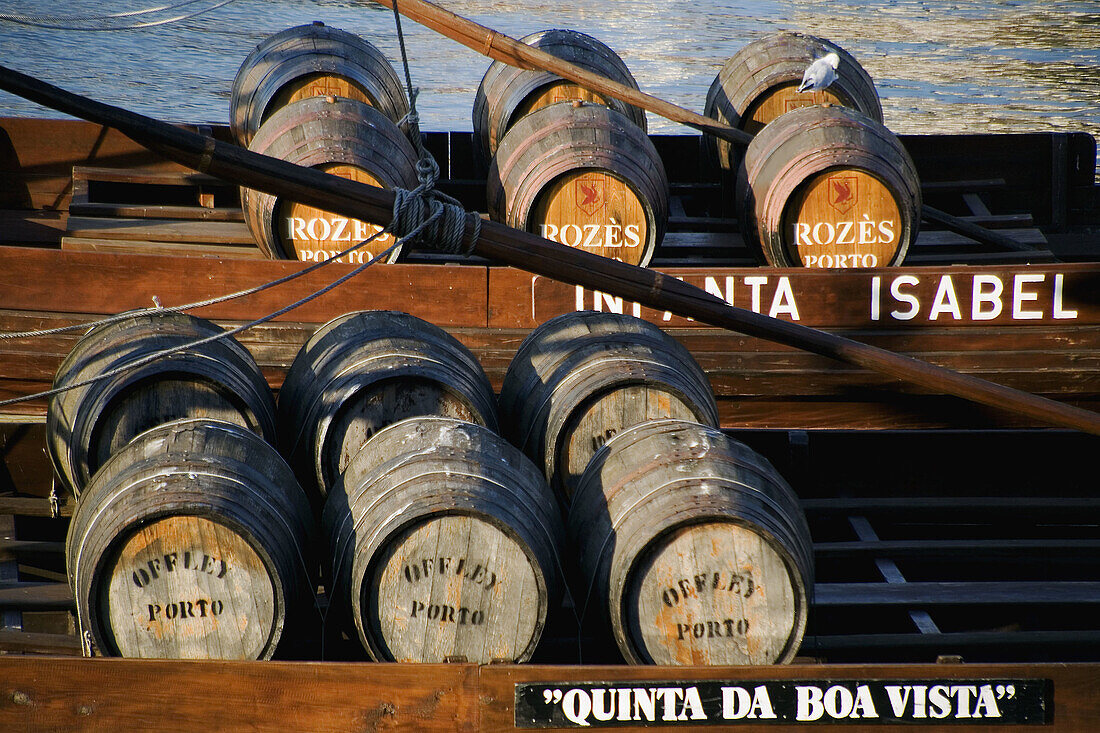 Ancient-looking boat with empty casks of port wine advertises port-wine tasting lodges on south bank of Rio Douro, Porto, Portugal