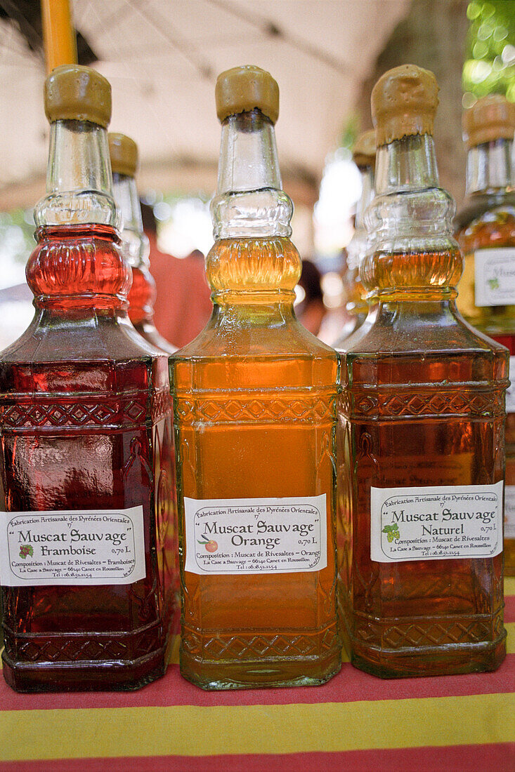 Bottles of vinegar on the market, Orange vinegar, Raspberry vinegar, Collioure, Languedoc-Roussillon, South France, France