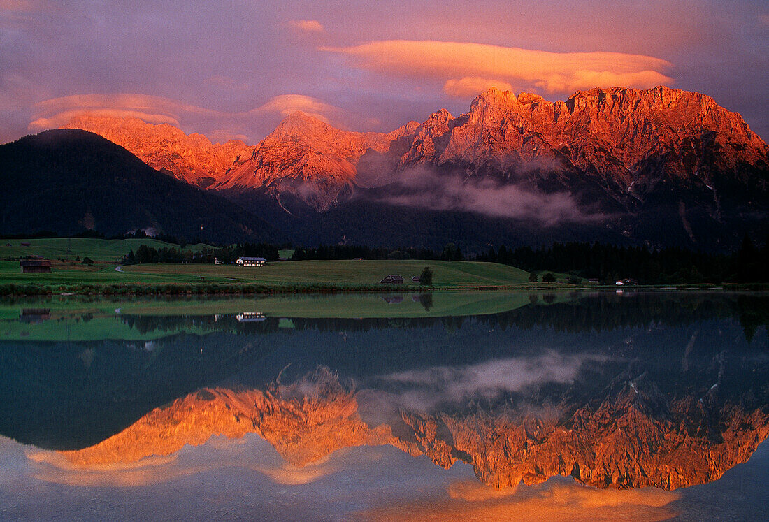 Mountains in the evening light reflecting in lake Schmalensee, Bavaria, Germany, Europe