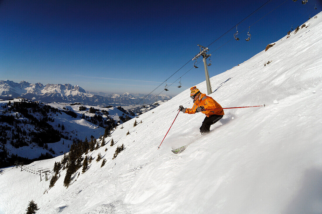 Skier at the descent on a mountain side, Kitzbuehel Alps, Tyrol, Austria, Europe