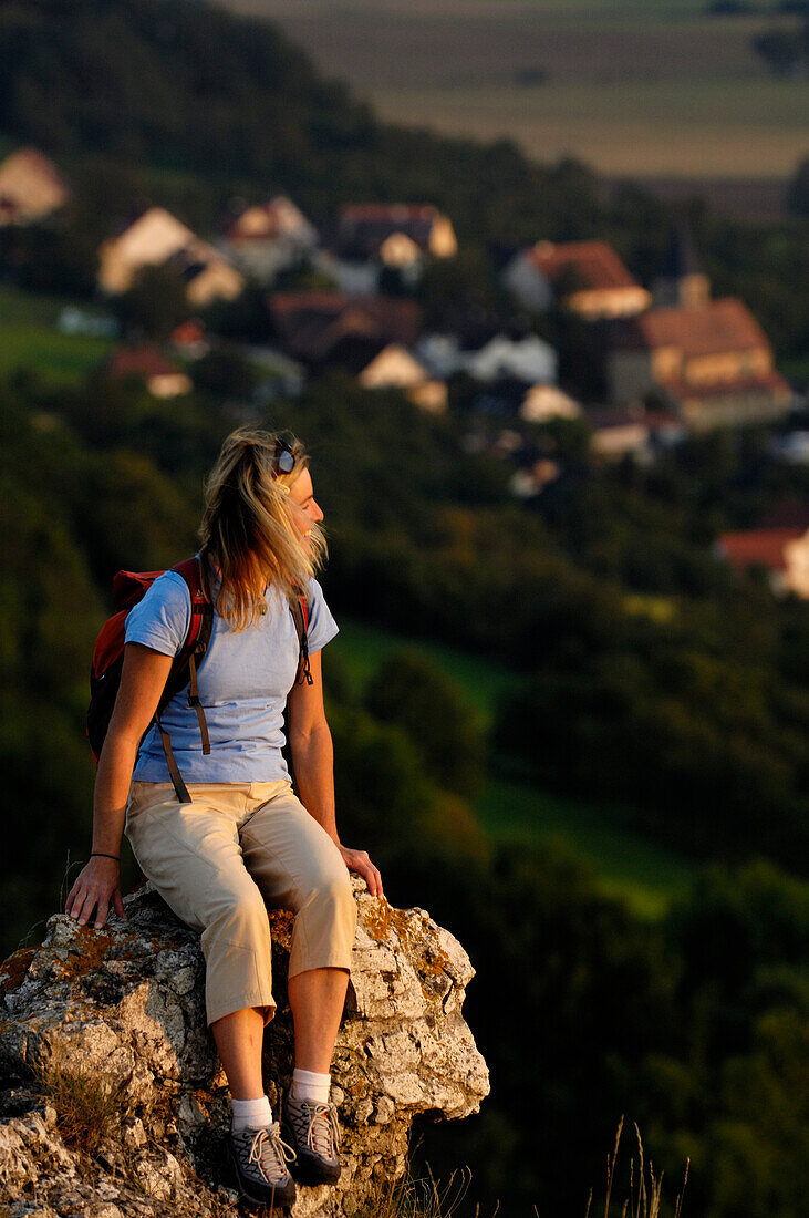 Frau auf einem Berg betrachtet die Aussicht, Walberla, Bayern, Deutschland, Europa