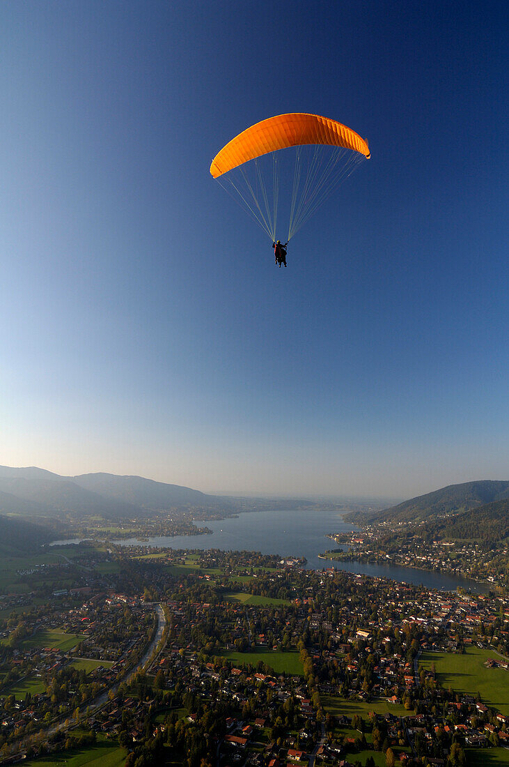 Person paragliding near Lake Tegernsee, near Rottach-Egern, Tegernsee, Upper Bavaria, Bavaria, Germany