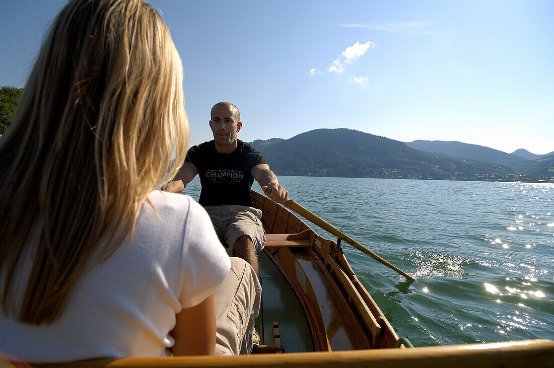 Couple in a rowing boat on Lake Tegernsee, Upper Bavaria, Bavaria, Germany