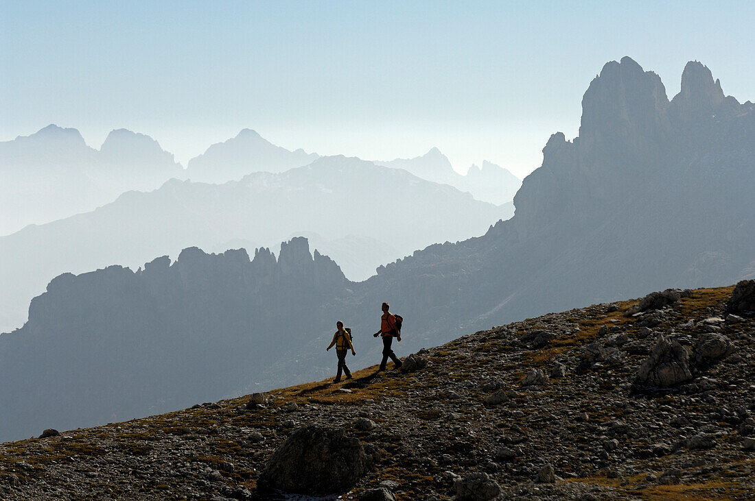 Couple hiking in the mountains, Val di Fassa, Rosengarten, Dolomites, Trento, South Tyrol, Italy