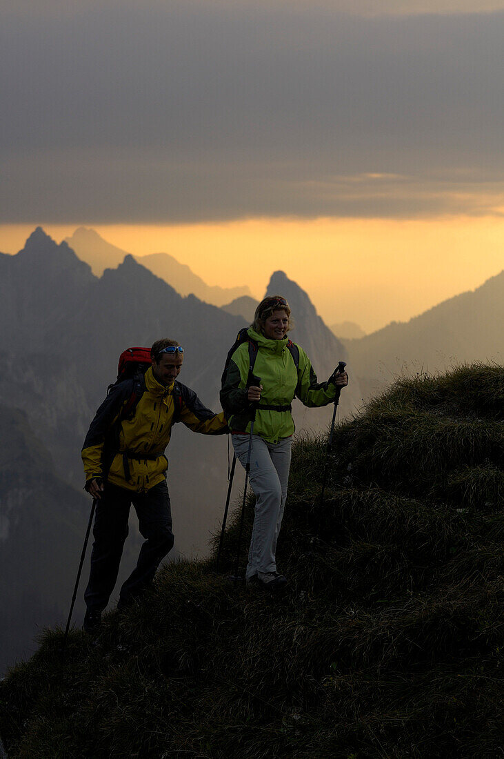 Hikers at ascent to the Klammspitze in the evening, Klammspitze, Ammergau Alps, Bavaria, Germany, Europe