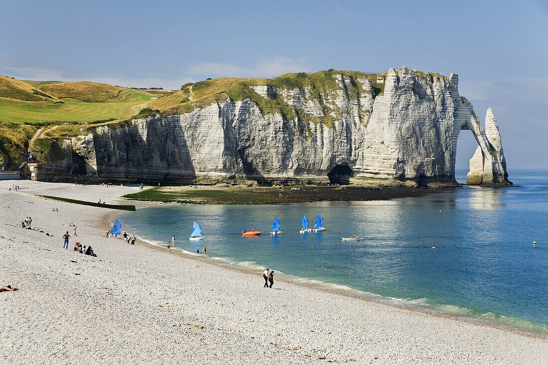 Cliffs, natural arch and stone beach in Etretat, Le Havre, Seine-Maritime departament, Haute-Normandie region, France, Europe