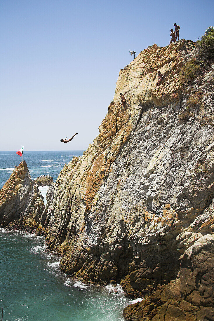 Cliff diver, a clavadista, diving off the cliffs at La Quebrada, Acapulco, Guerrero State, Mexico