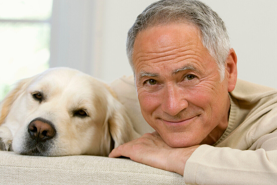 Adult, Adults, Animal, Animals, At home, Caucasian, Caucasians, Close up, Close-up, Closeup, Color, Colour, Companion, Companions, Contemporary, Couch, Couches, Dog, Dogs, Domestic animal, Domestic animals, face, faces, Facing camera, Gray-haired, Grey ha