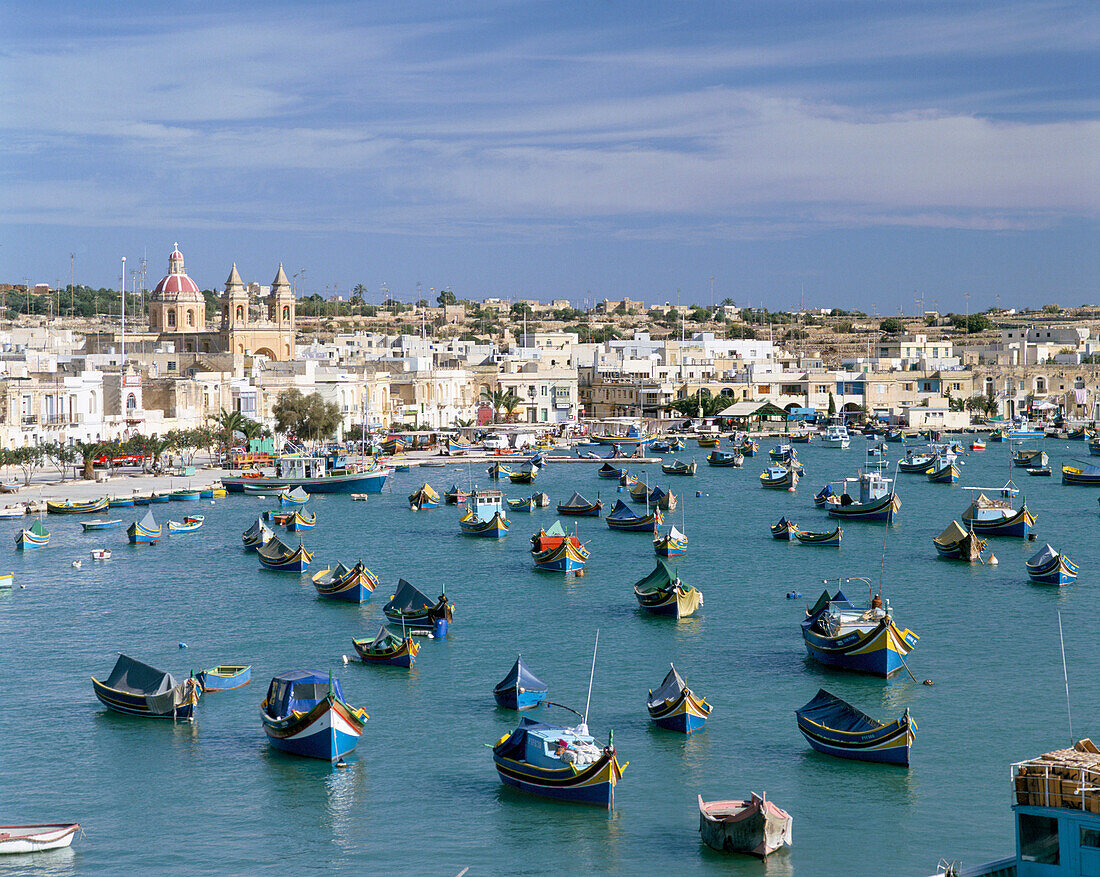 View of bay with colourful fishing boats, Marsaxlokk, Malta, Maltese Islands