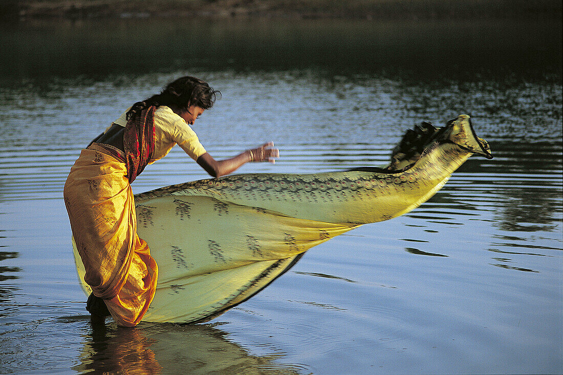 WOMAN WASHING A SARI, MYSORE REGION, KARNATAKA, INDIA
