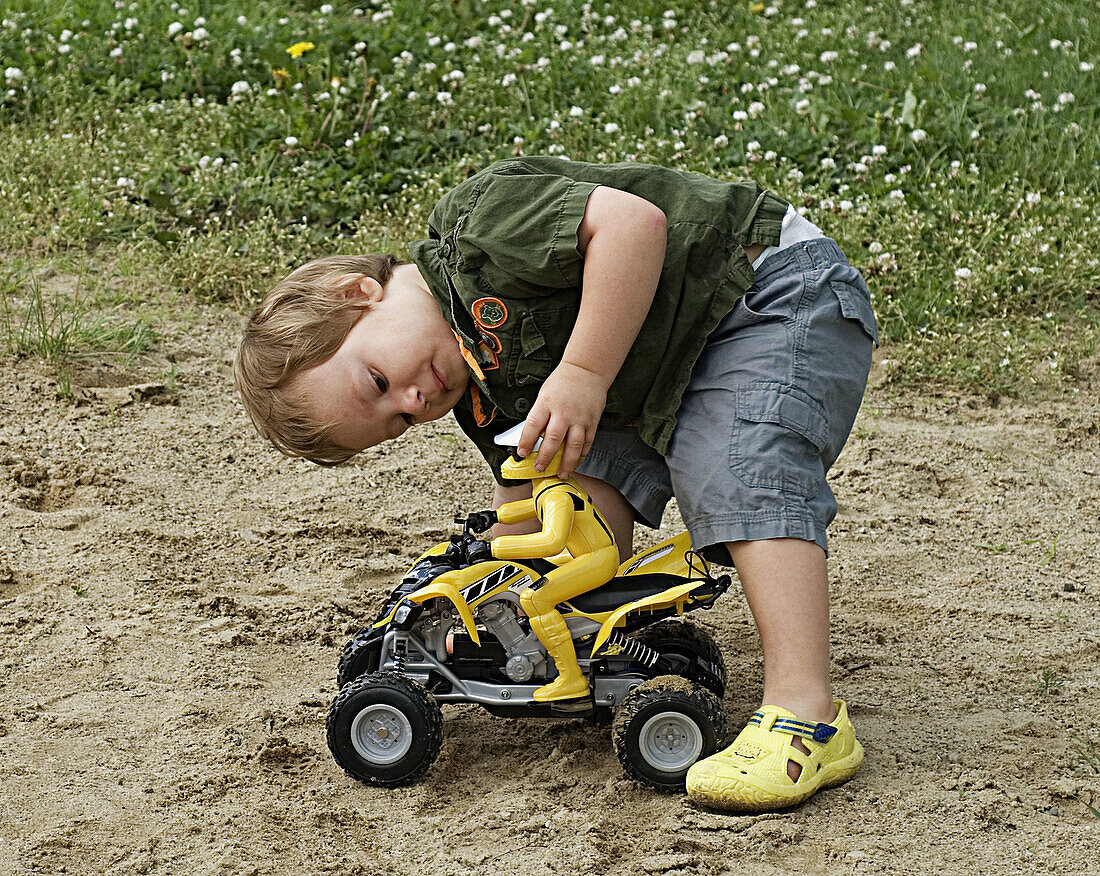 Atv, Boy, Car, Child, Color, Colour, Contemporary, Horizontal, Little, Motorcycle, Play, Playing, Shoe, Yellow, Young, V93-753255, agefotostock