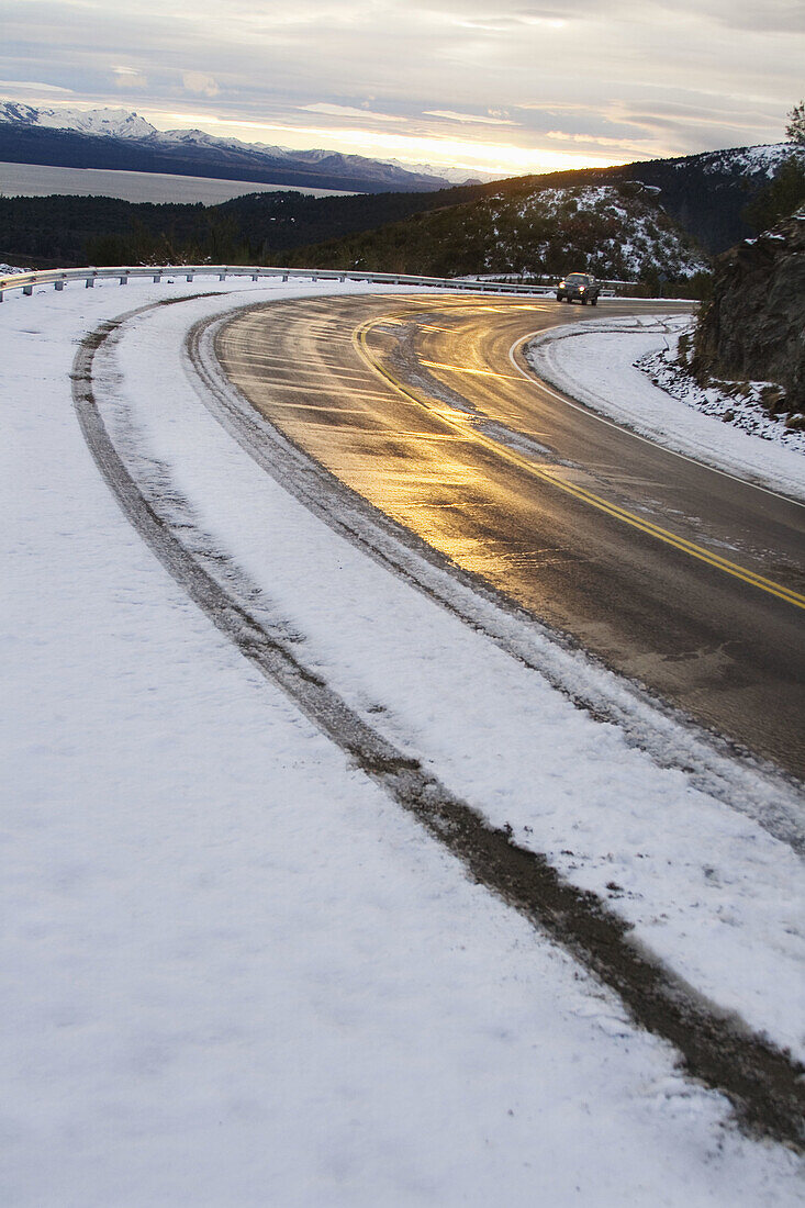 Asphalt, Auto, Automobile, Automobiles, Autos, Bend, Bends, Car, Cars, Cold, Coldness, Color, Colour, Curve, Curves, Danger, Daytime, exterior, Hazard, Highway, Highways, outdoor, outdoors, outside, Reflection, Reflections, Road, Roads, Slippery, Snow, Sn