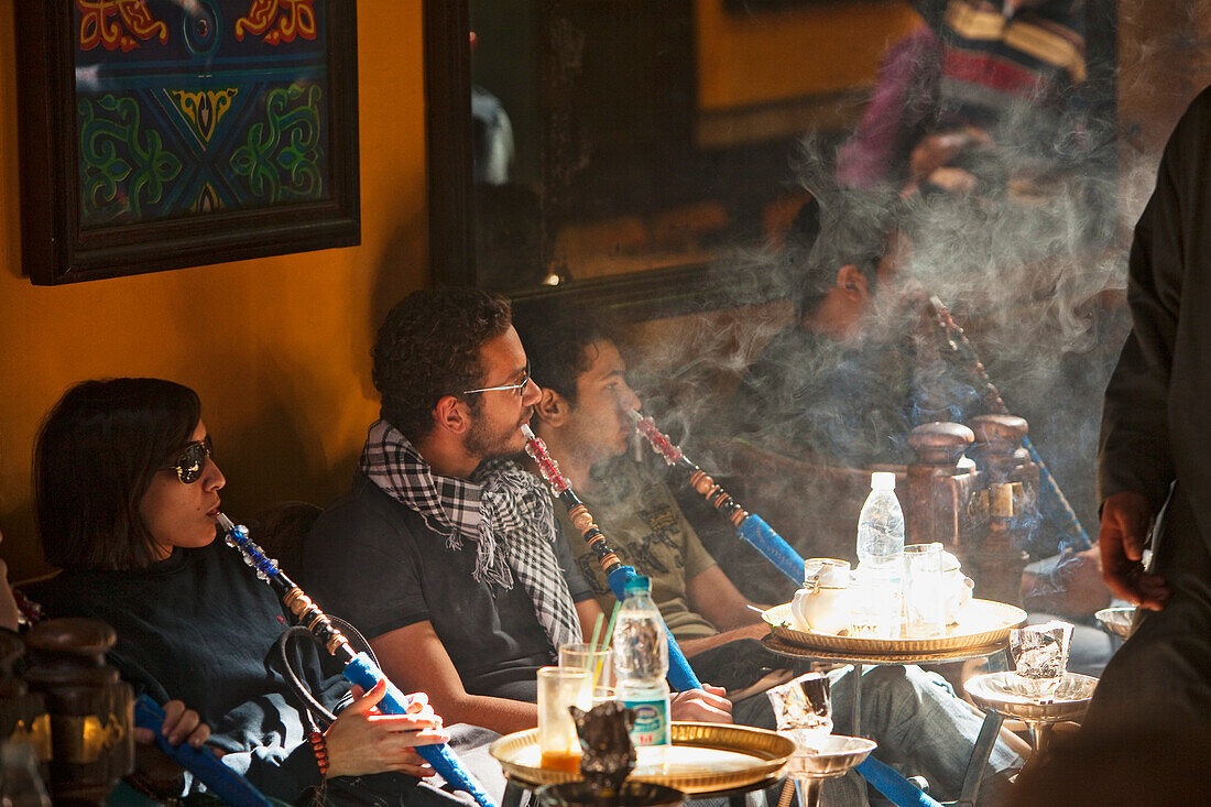 People smoking a waterpipe at the Cafe Fishawi in Khan el-Khalili bazaar, Cairo, Egypt, Africa