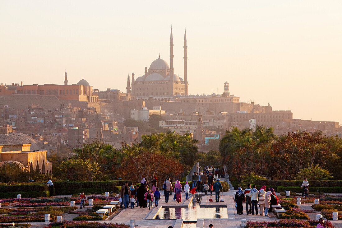 People strolling at Al Azhar Park, in the background the citadel with the mosque of Muhammad Ali, Cairo, Egypt, Africa