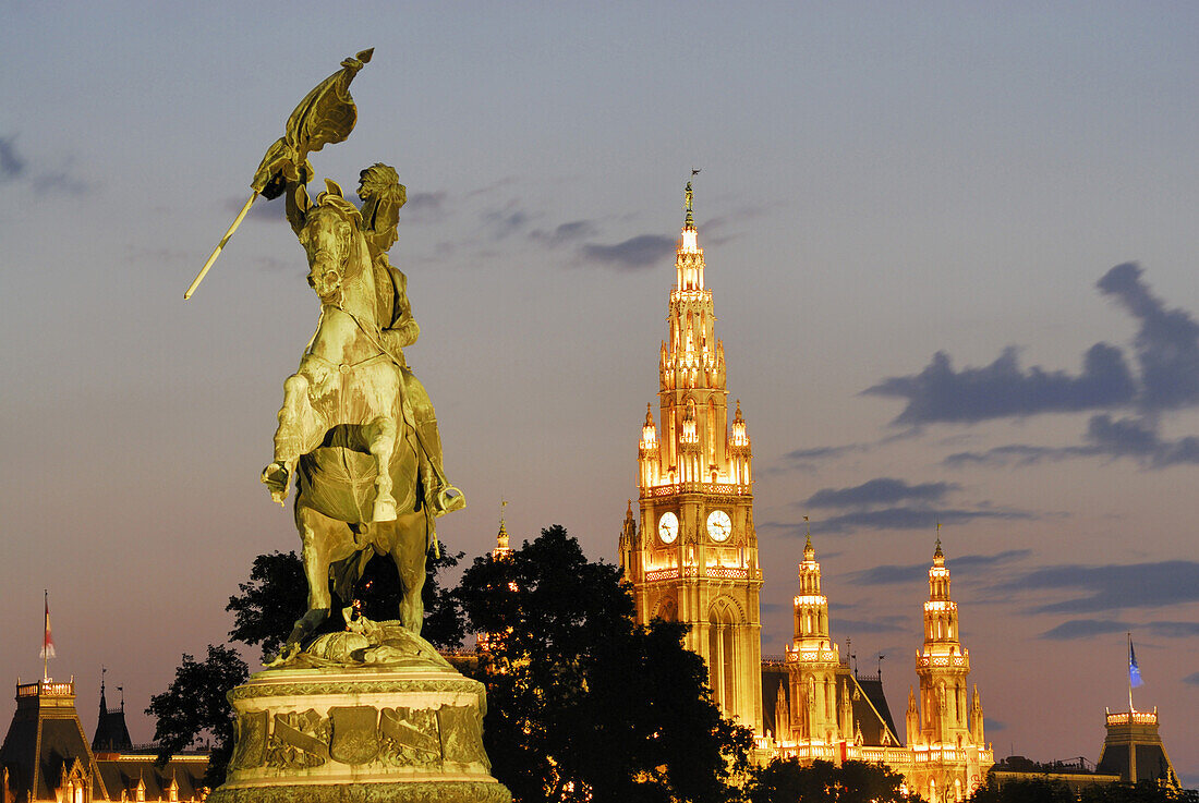 Archduke Charles equestrian monument, illuminated city hall in background, Vienna, Austria