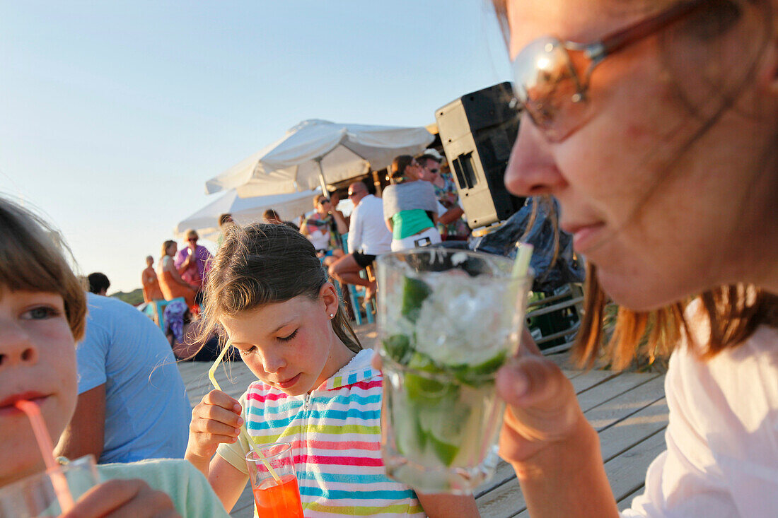 Mother with children in the Pirata Bus beach bar, Formentera, Balearic Islands, Spain