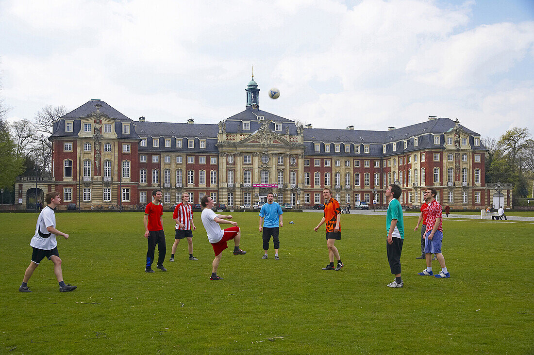 Kickers playing in front of a castle, Muenster, North Rhine-Westphalia, Germany