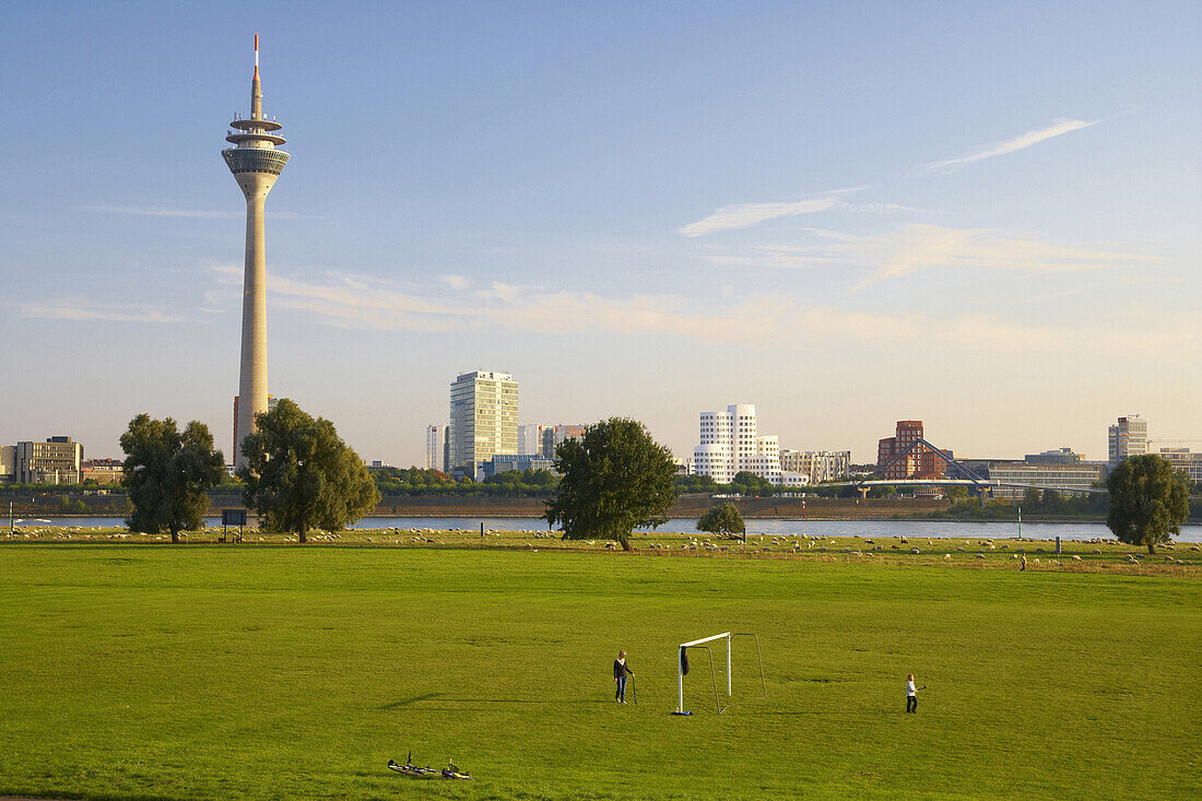 View over soccer ground to Rhine Towe and Media Harbor, Duesseldorf, North Rhine-Westphalia, Germany