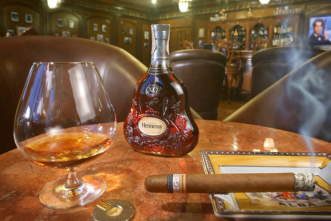 A glass of whiskey and a smoking cigar at the cigar lounge at Peacock Garden resort, Baclayon, Bohol, Philippines, Asia