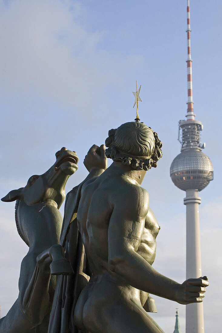 Bronze sculpture The Horse Tamer, Television Tower in background, Berlin, Germany