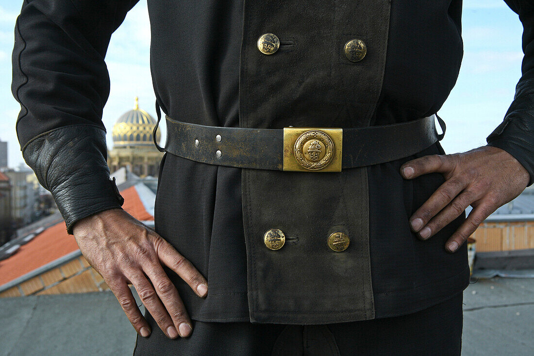 Chimney sweeps standing on roof, dome of New Synagogue, in background, Berlin, Germany