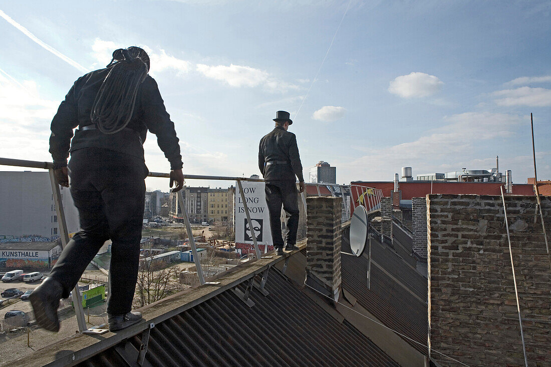 Chimney sweep on corrugated iron roof, Berlin, Germany