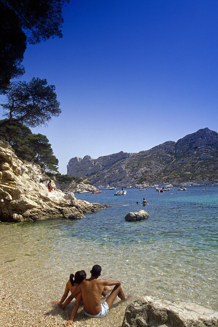 Young couple on the beach under blue sky, Calanque de Sormiou, Cote d´Azur, Provence, France, Europe