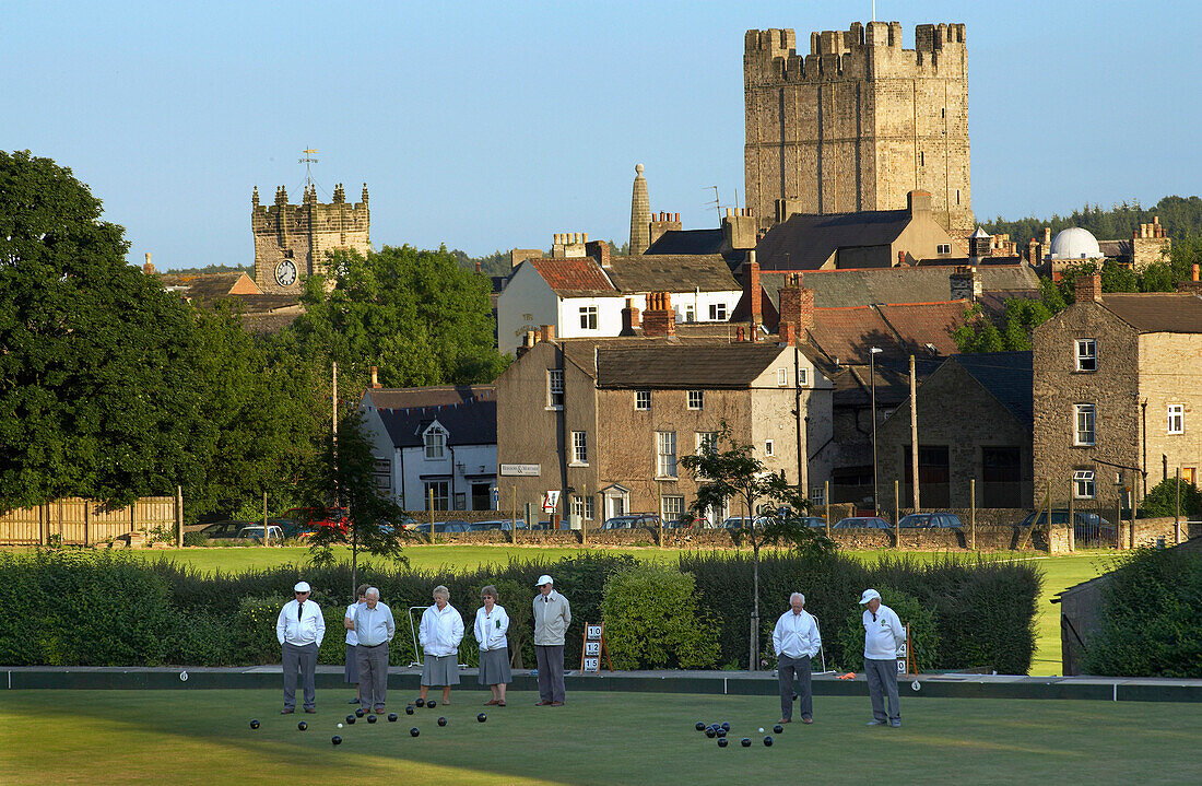 Bowls match in progress with town and castle in background, Richmond, Yorkshire, UK, England