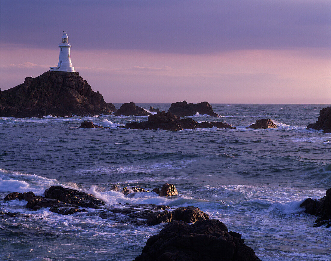 View of Corbiere Lighthouse in evening sunlight, Corbiere Point, Jersey, UK, Channel Islands