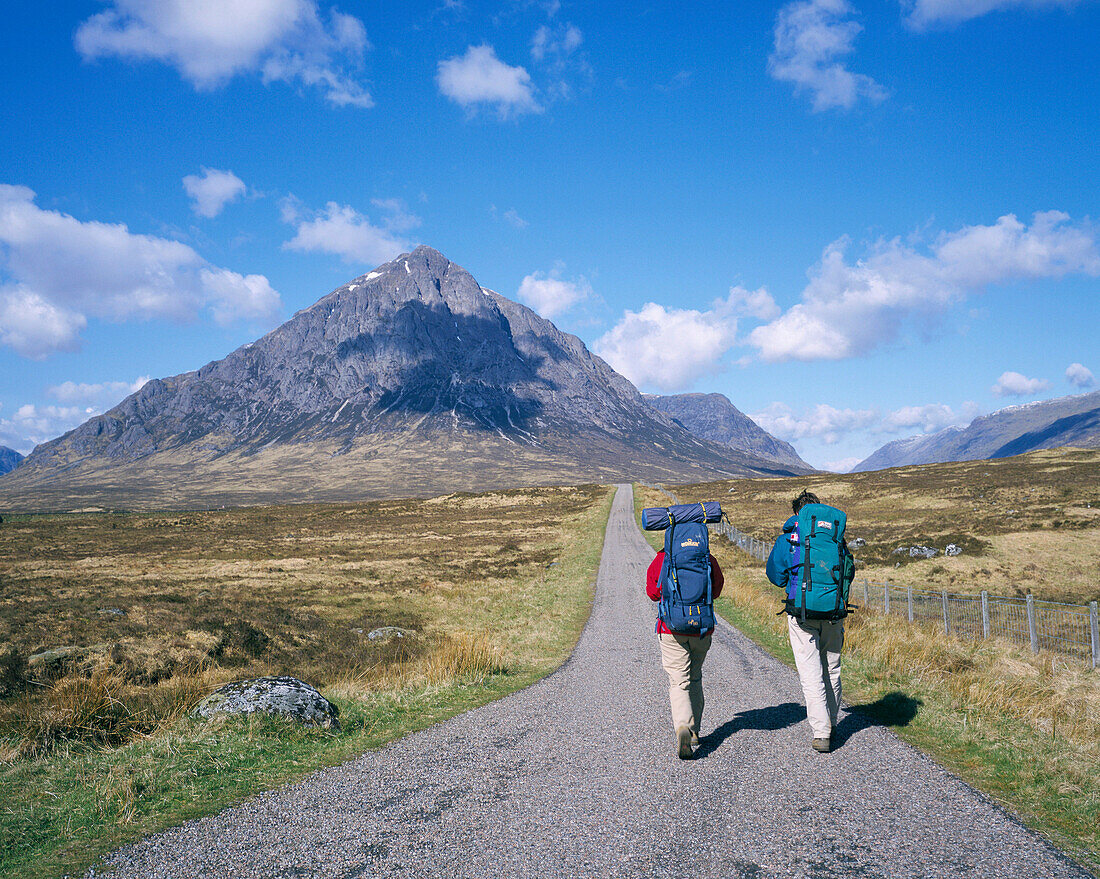 Walkers on the road to Buachaille Etive Mor mountain, Glen Coe, Highland, UK, Scotland