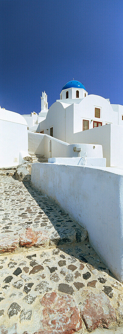 Path leading to church with blue dome, Oia, Santorini Island, Greek Islands