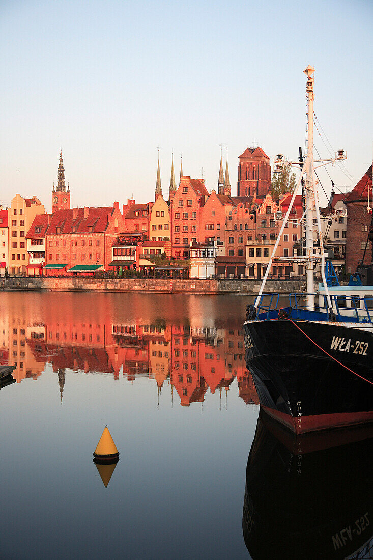 City skyline reflected in River Motlawa at sunrise, Gdansk, Poland