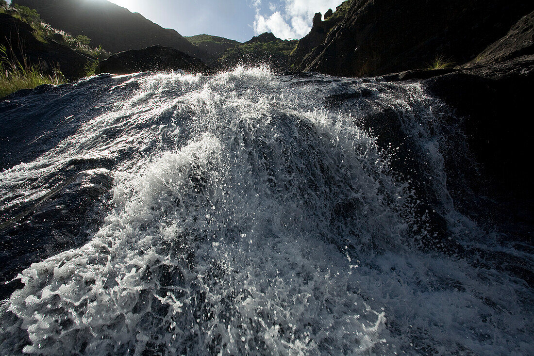 Waterfall in the mountains in the sunlight, , Barranco del Charco Azul, El Risco valley, Parque Natural de Tamadaba, Gran Canaria, Canary Islands, Spain, Europe